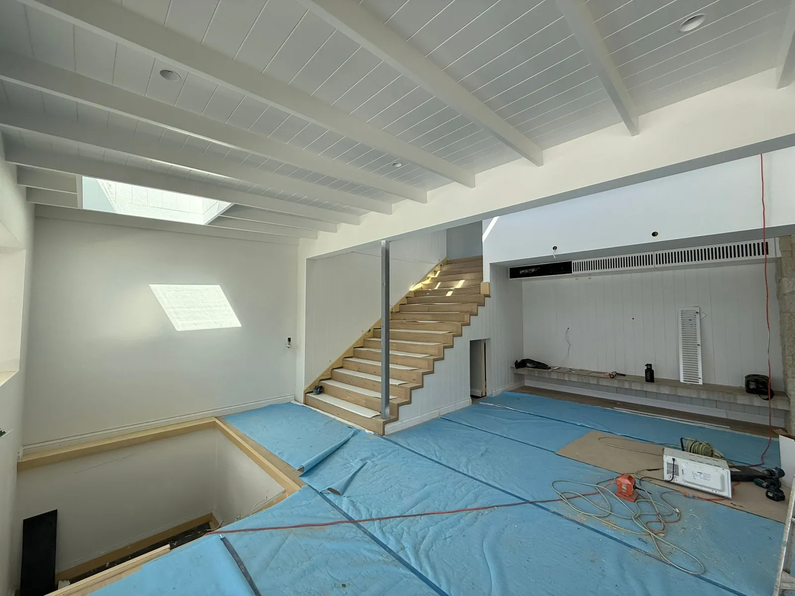 Open plan living with timber staircase and skylights